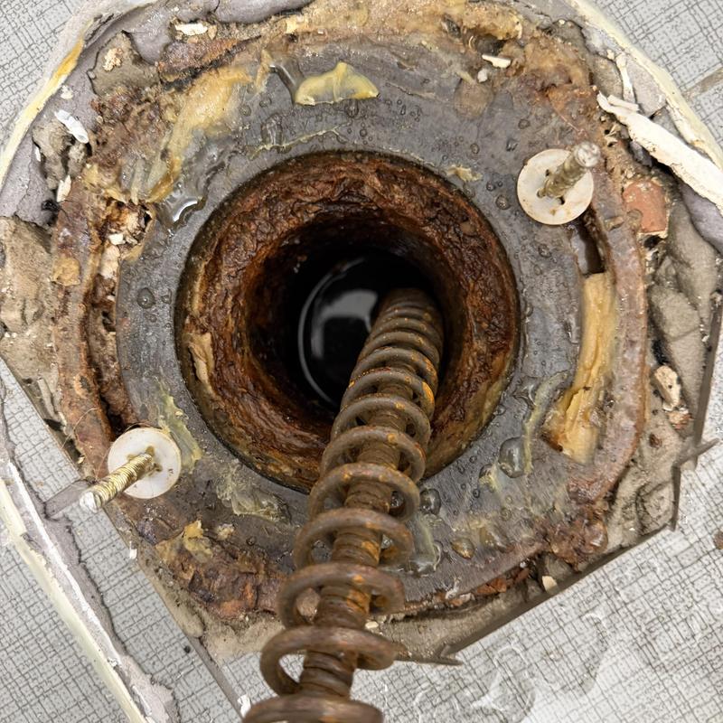 Main line drain with rusted cleaning auger inside Main line drain with rusted cleaning auger inside