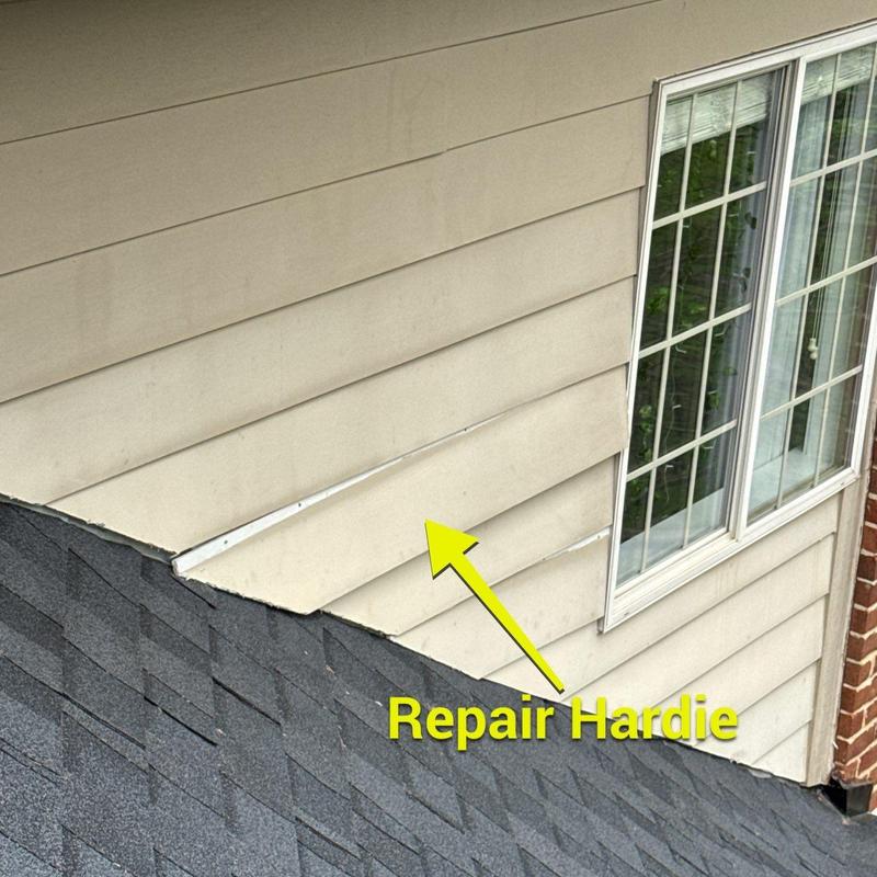 Hardie siding near roofline with damage