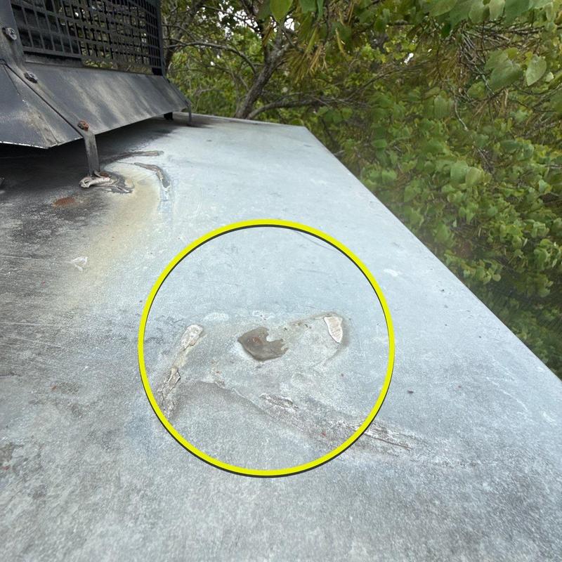 Metal roof flashing with corrosion damage marked in yellow