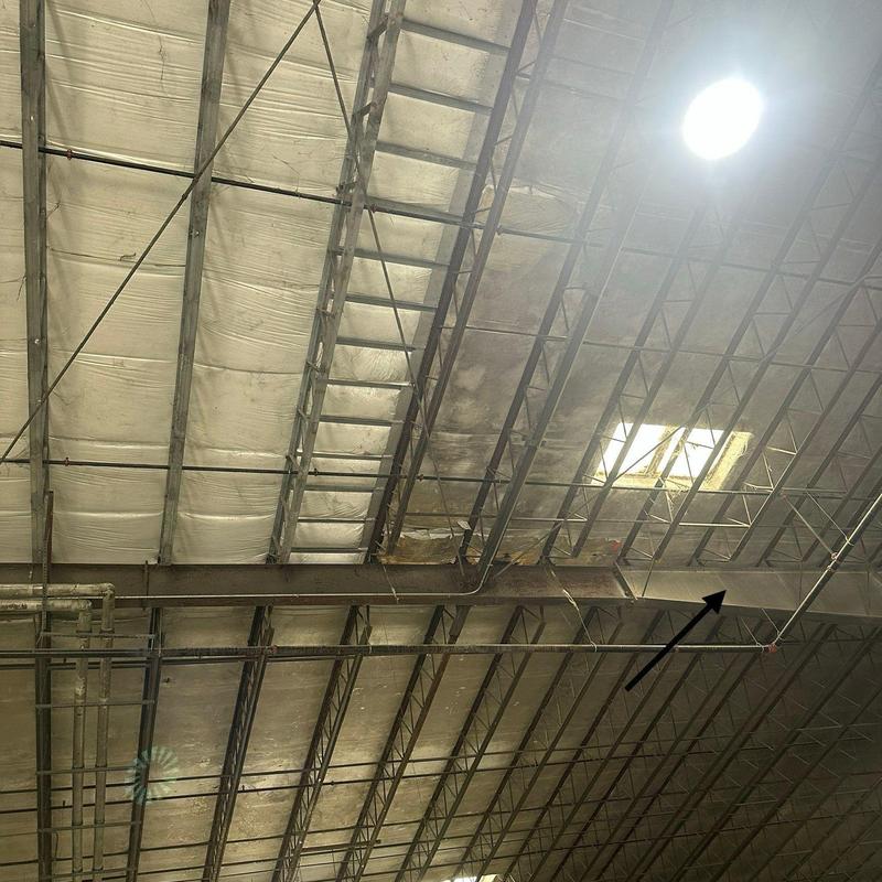 Roof purlin and insulation damage in warehouse ceiling Roof purlin and insulation damage in warehouse ceiling