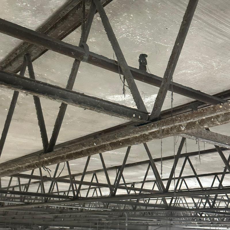 Steel roof trusses with rust and damage on industrial roof Steel roof trusses with rust and damage on industrial roof