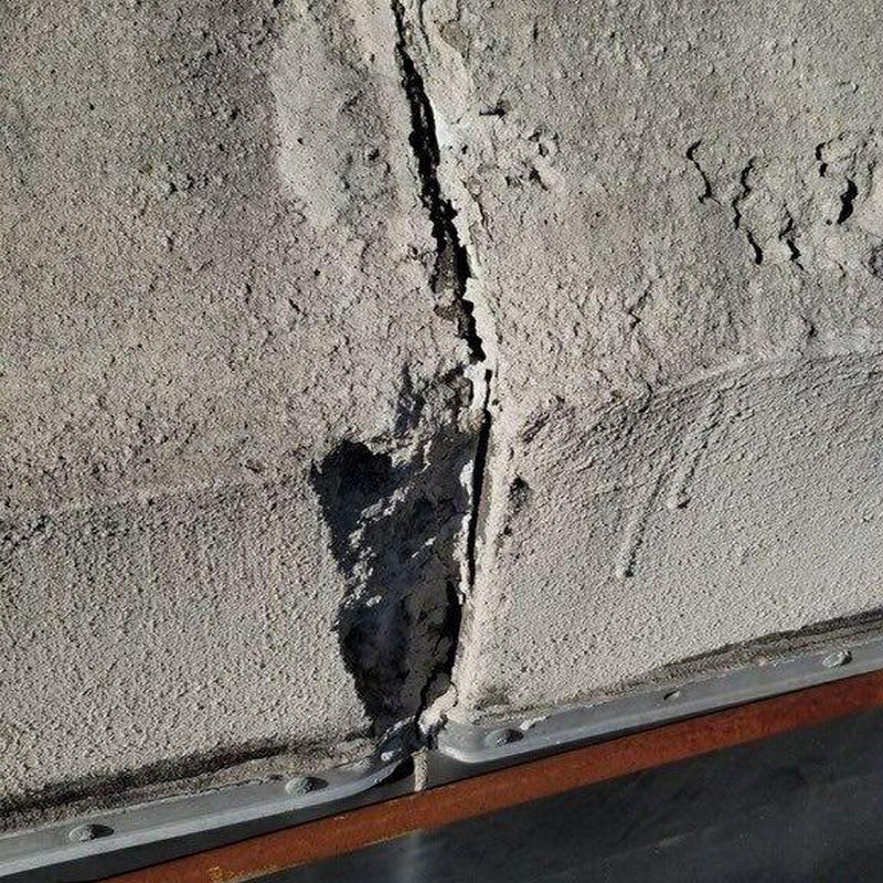 Commercial roof crack and damaged concrete surface close-up Commercial roof crack and damaged concrete surface close-up