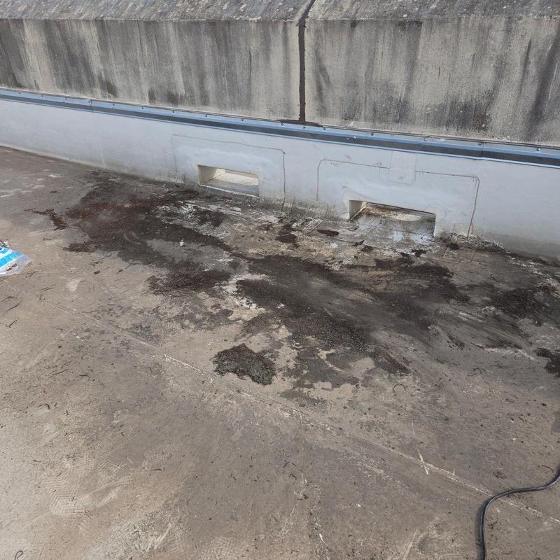 Commercial roof membrane with surface damage and staining Commercial roof membrane with surface damage and staining
