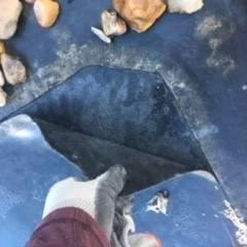 Commercial roofing membrane inspection with lifted seam and debris Commercial roofing membrane inspection with lifted seam and debris