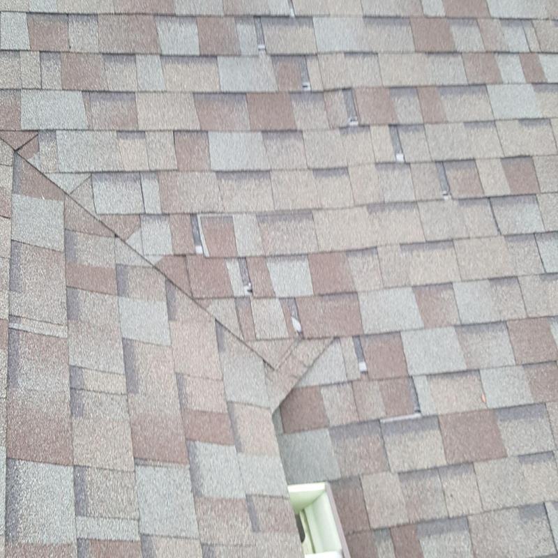Asphalt shingle roof with visible wear and material gaps Asphalt shingle roof with visible wear and material gaps