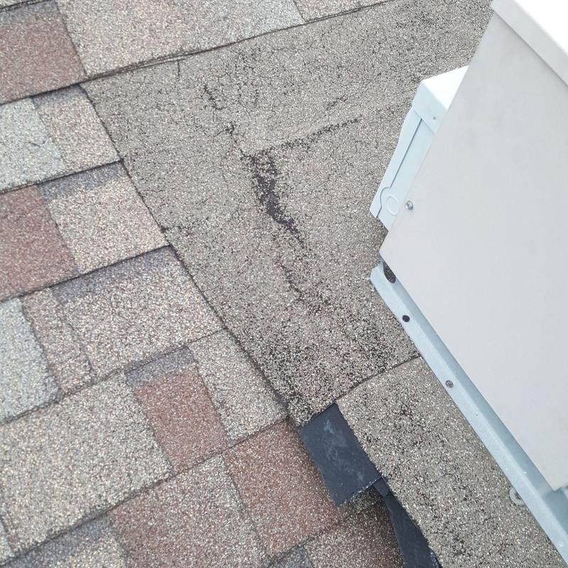 Asphalt shingle roof with weathering near HVAC unit Asphalt shingle roof with weathering near HVAC unit