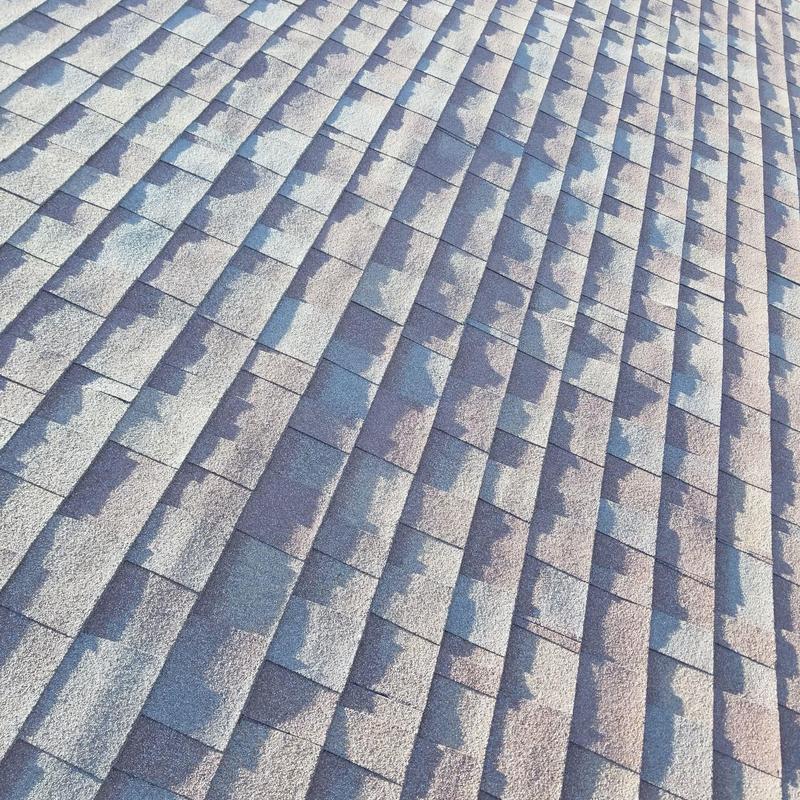 Asphalt shingle roof with sunlight and shadow pattern Asphalt shingle roof with sunlight and shadow pattern