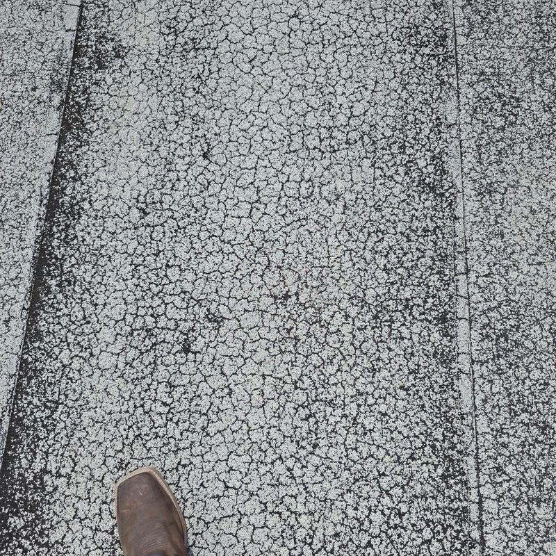 Commercial roof surface with weathered granules Commercial roof surface with weathered granules