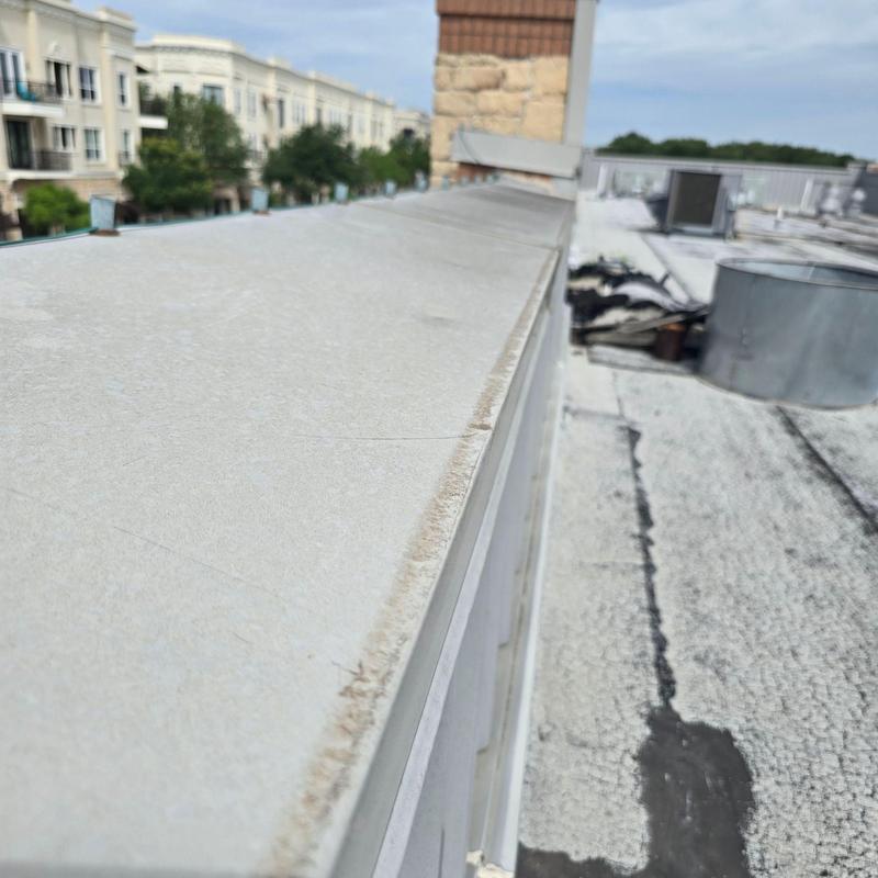 Parapet wall cap on commercial flat roof Parapet wall cap on commercial flat roof