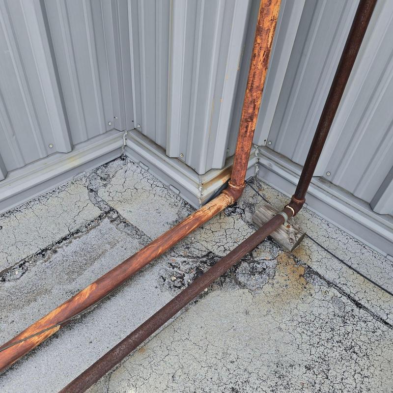 Roof drain pipes with rust and roof surface cracks Roof drain pipes with rust and roof surface cracks