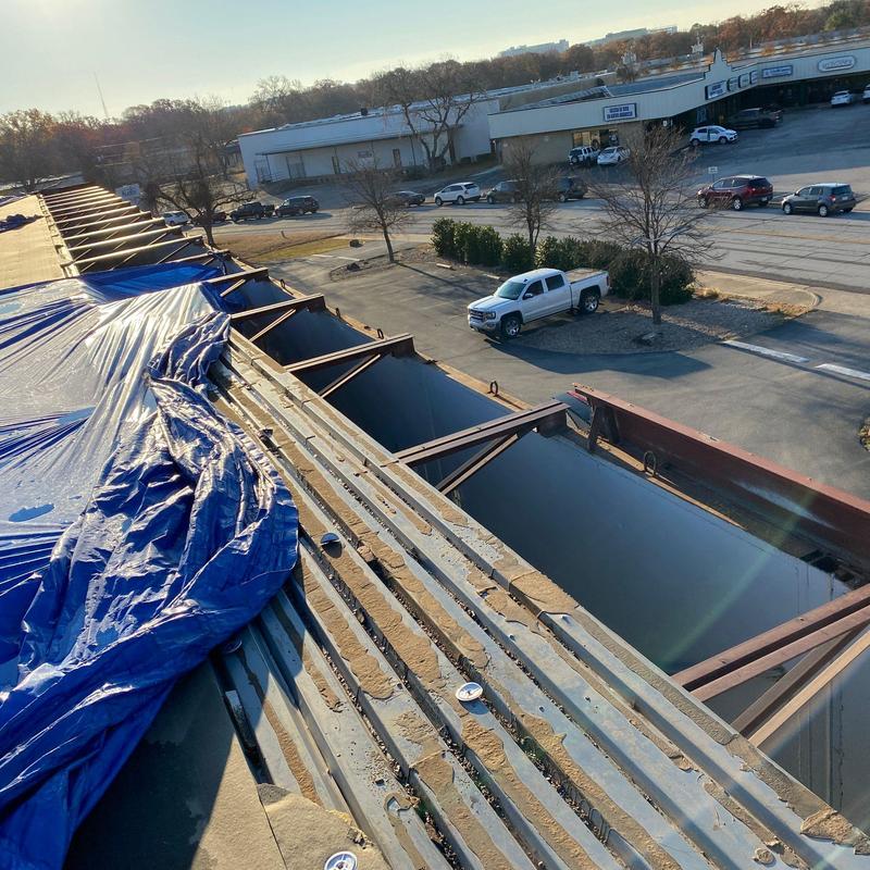 Metal roof deck with tarps and structural supports Metal roof deck with tarps and structural supports