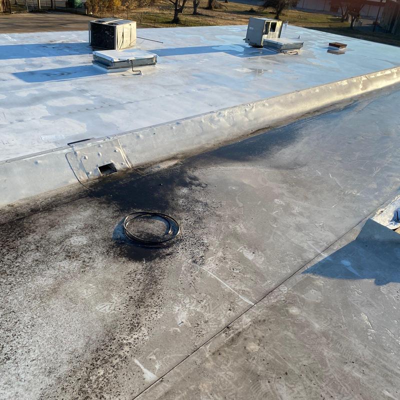 Commercial roof membrane with wear and debris buildup Commercial roof membrane with wear and debris buildup
