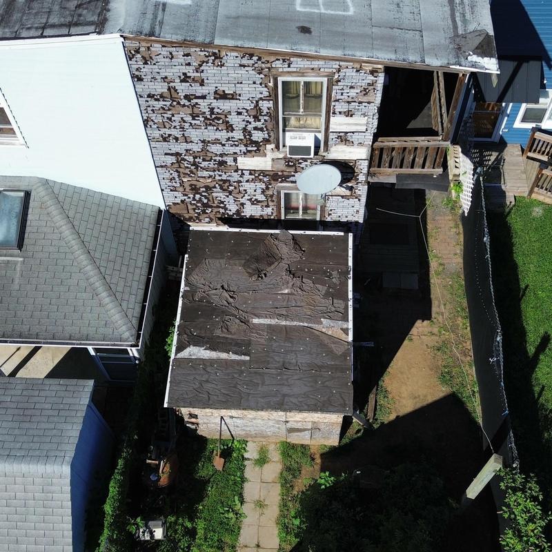 Detached shed roofing with torn underlayment and decking Detached shed roofing with torn underlayment and decking