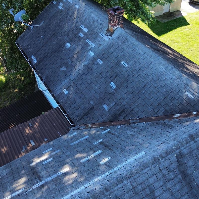 Asphalt shingle roof with significant shingle loss and wear Asphalt shingle roof with significant shingle loss and wear