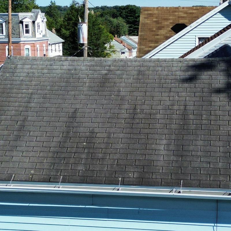 Asphalt shingle roof with significant shingle loss Asphalt shingle roof with significant shingle loss