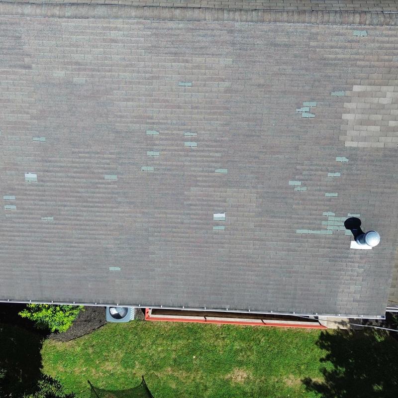 Three-tab shingle roof with storm damage patches Three-tab shingle roof with storm damage patches