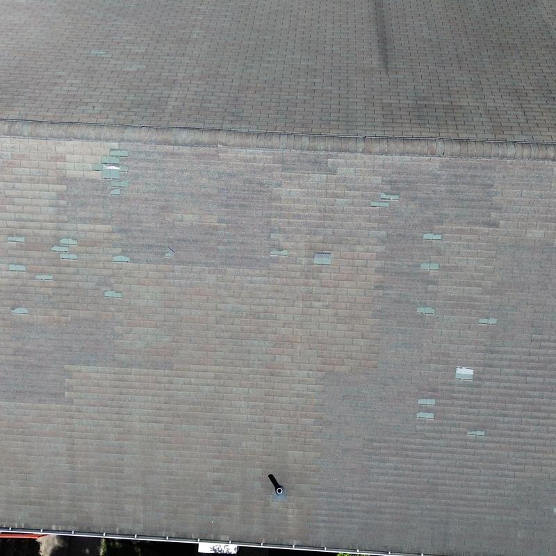 Three-tab shingle roof with storm damage patches Three-tab shingle roof with storm damage patches