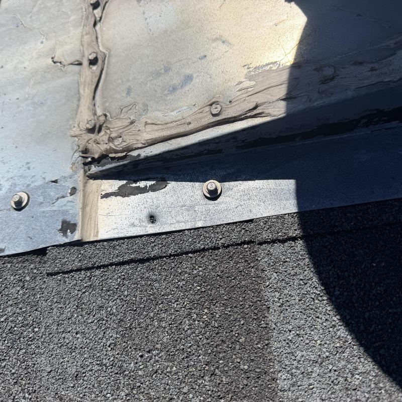 Rubber grommets on roof metal screw heads Rubber grommets on roof metal screw heads