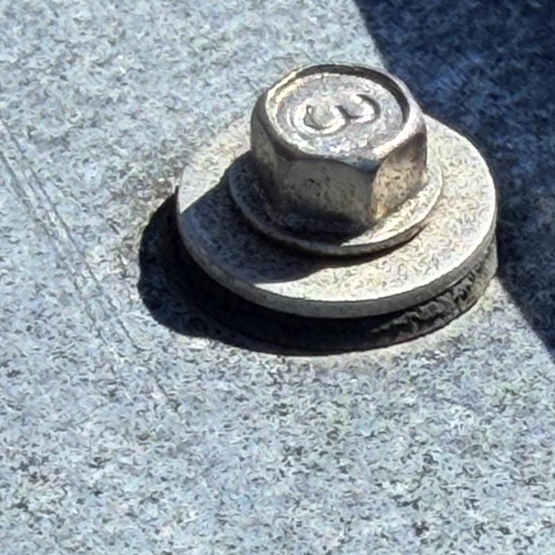 Rubber grommet around roofing screw head deteriorated Rubber grommet around roofing screw head deteriorated