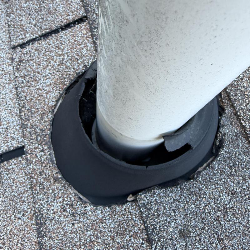 Deteriorated pipe boot on shingle roof with staples Deteriorated pipe boot on shingle roof with staples