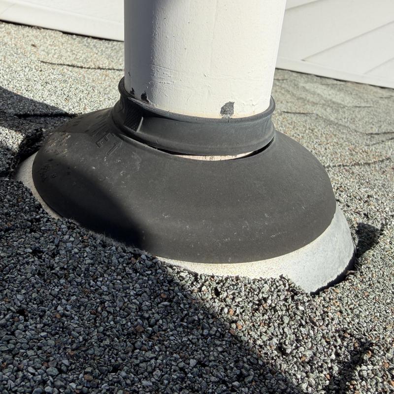 Pipe boot with cracking on shingle roof close-up Pipe boot with cracking on shingle roof close-up