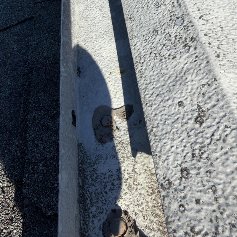 Gutter hangers with missing screws and erosion damage Gutter hangers with missing screws and erosion damage