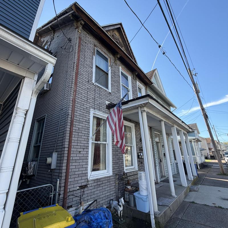 Brick exterior with exposed wood inspection on old home Brick exterior with exposed wood inspection on old home