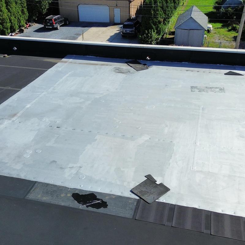 EPDM roof with punctures and patch repairs EPDM roof with punctures and patch repairs