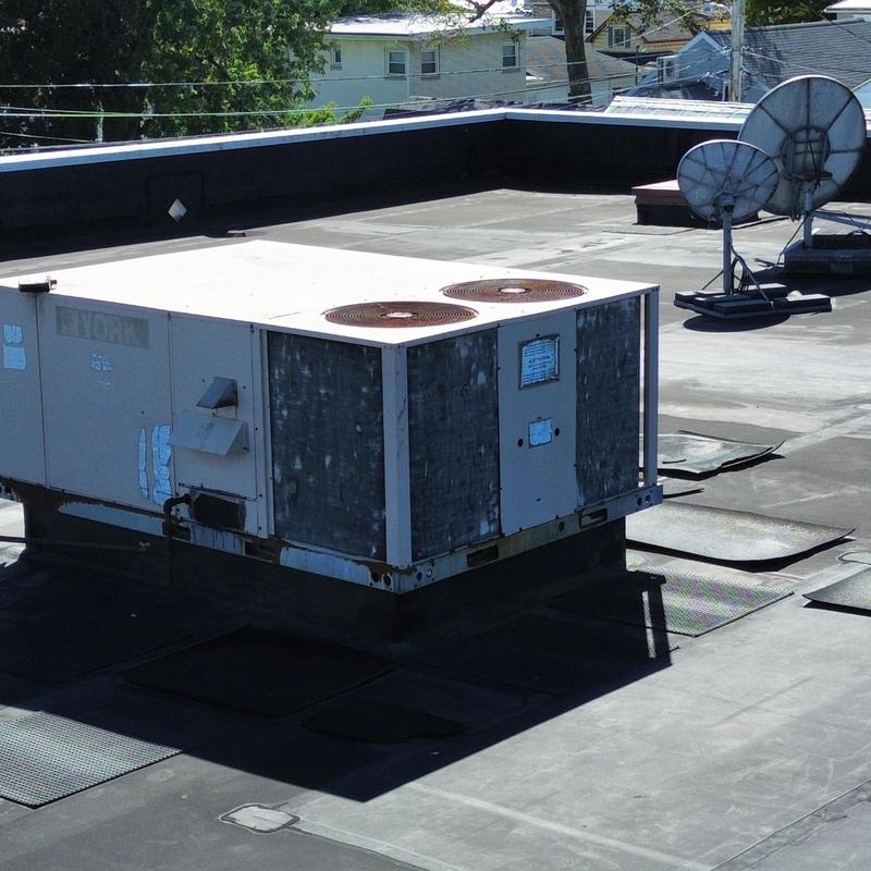 Commercial rooftop HVAC unit with EPDM roof punctures Commercial rooftop HVAC unit with EPDM roof punctures