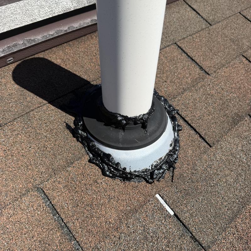 Roof vent pipe flashing with tar seal on asphalt shingles Roof vent pipe flashing with tar seal on asphalt shingles