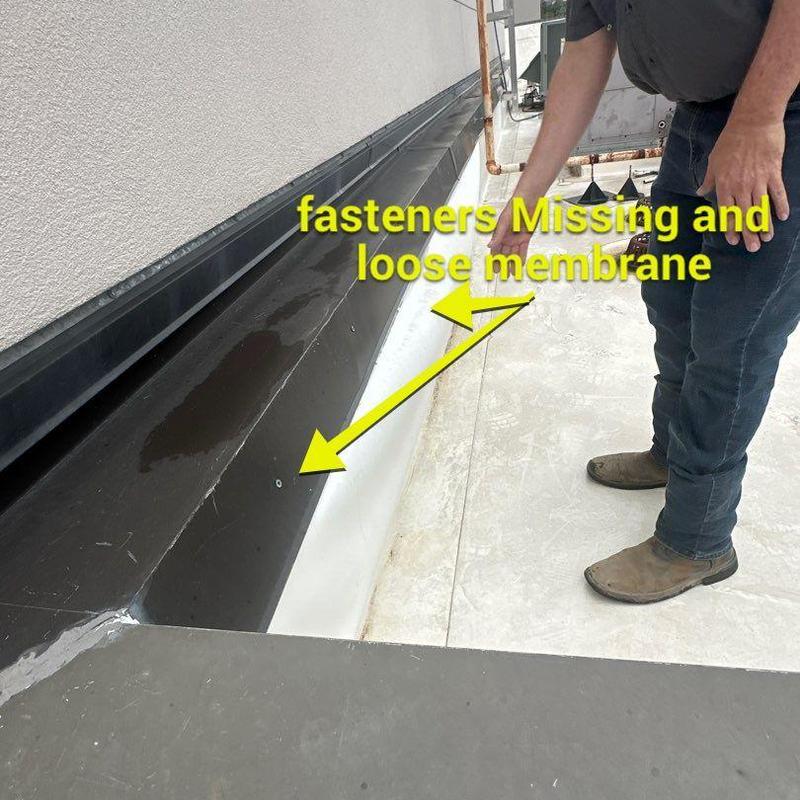 Roof membrane with missing fasteners and loose areas Roof membrane with missing fasteners and loose areas