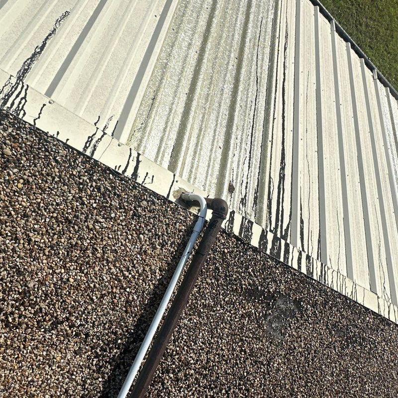 Metal roof panels and gravel roofing with vent pipe Metal roof panels and gravel roofing with vent pipe