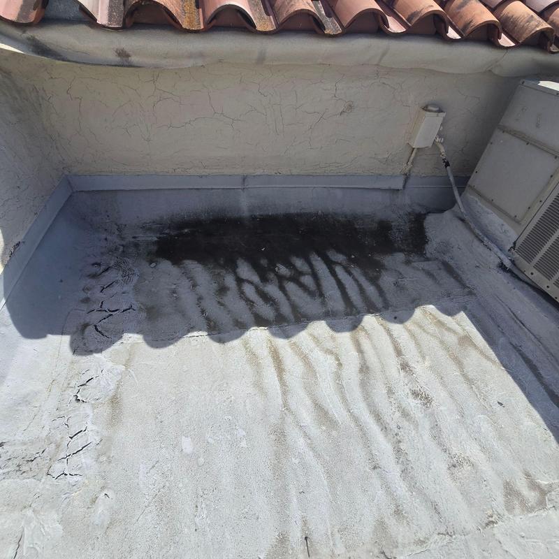 Flat roof membrane with water damage and cracking Flat roof membrane with water damage and cracking