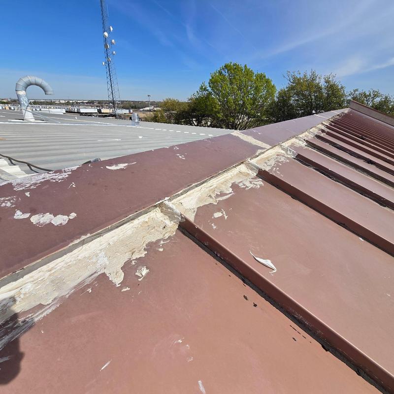 Metal roof ridge sealant deterioration on commercial building Metal roof ridge sealant deterioration on commercial building