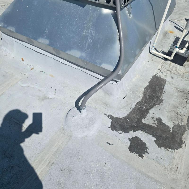 Roof flashing and sealant on commercial roof surface Roof flashing and sealant on commercial roof surface