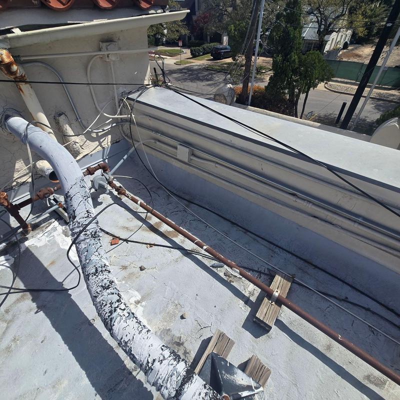 Roof drain pipe with weathering and cable lines on roof edge Roof drain pipe with weathering and cable lines on roof edge