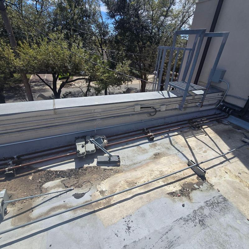 Commercial roof with electrical conduit and ladder access Commercial roof with electrical conduit and ladder access