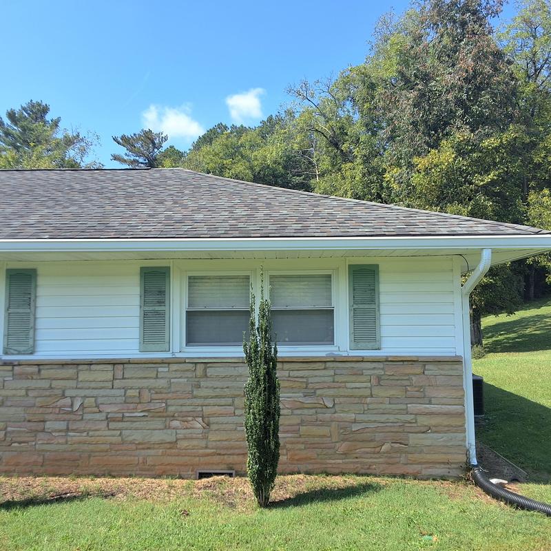 Asphalt shingle roof on single-story home with gutters