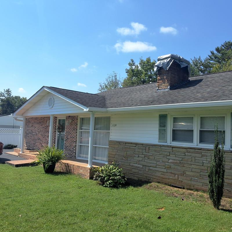Asphalt shingle roof with covered chimney inspection