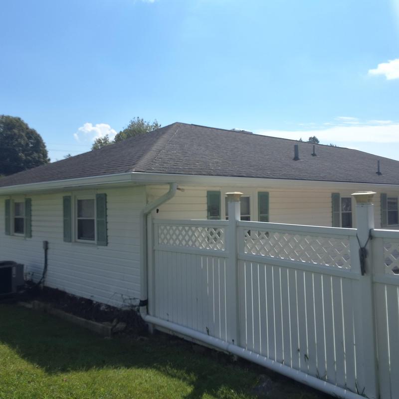 Asphalt shingle roof on residential home with fence