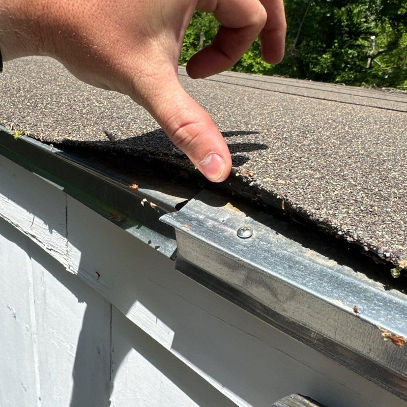 Asphalt shingle roof edge lifting during inspection