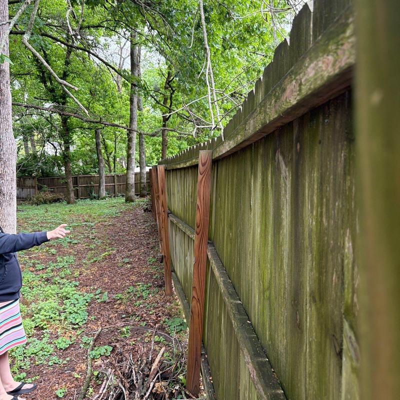 Wooden fence with new support posts installed