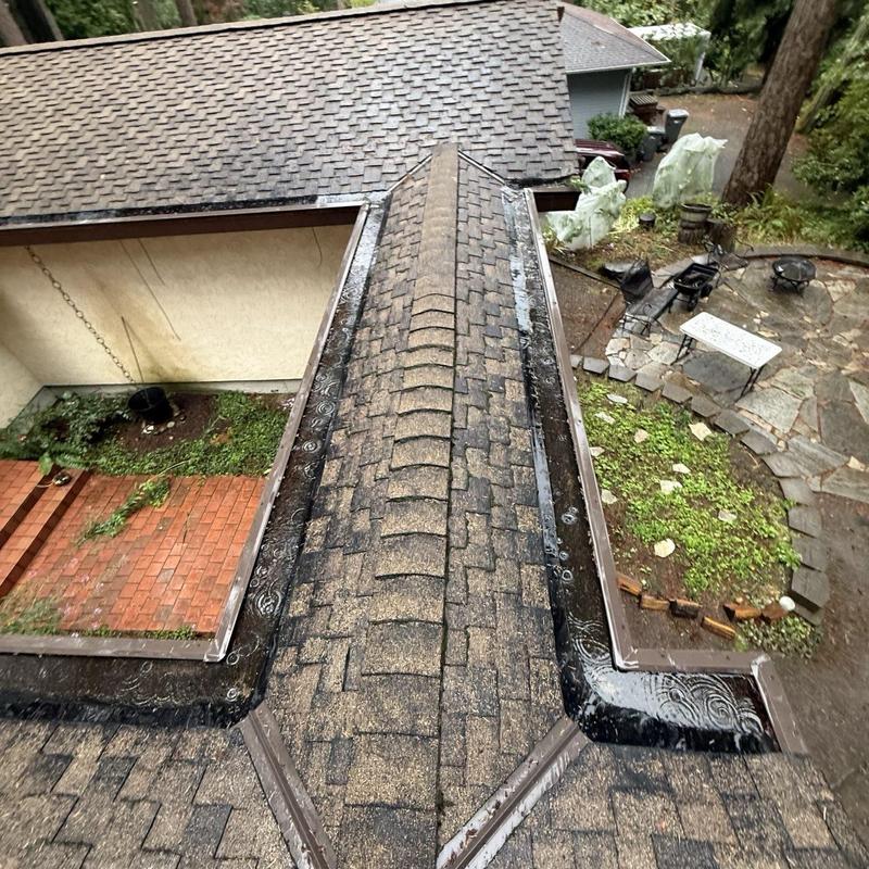 Asphalt shingle ridge and valley with metal flashing