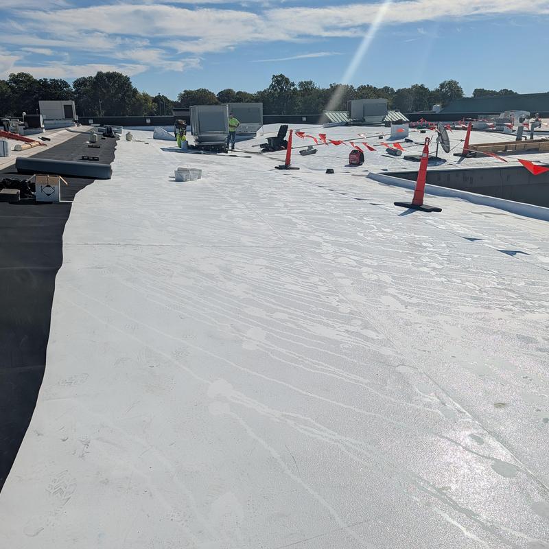 Commercial roof restoration with white coating application