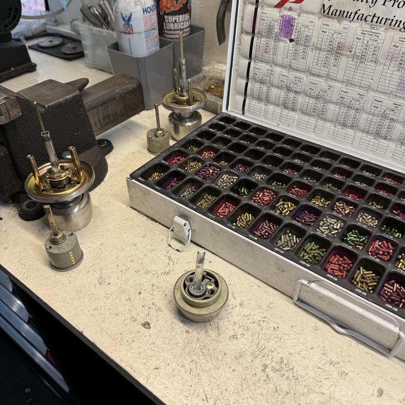 Rekeying lock pins and tumblers with key chart on bench
