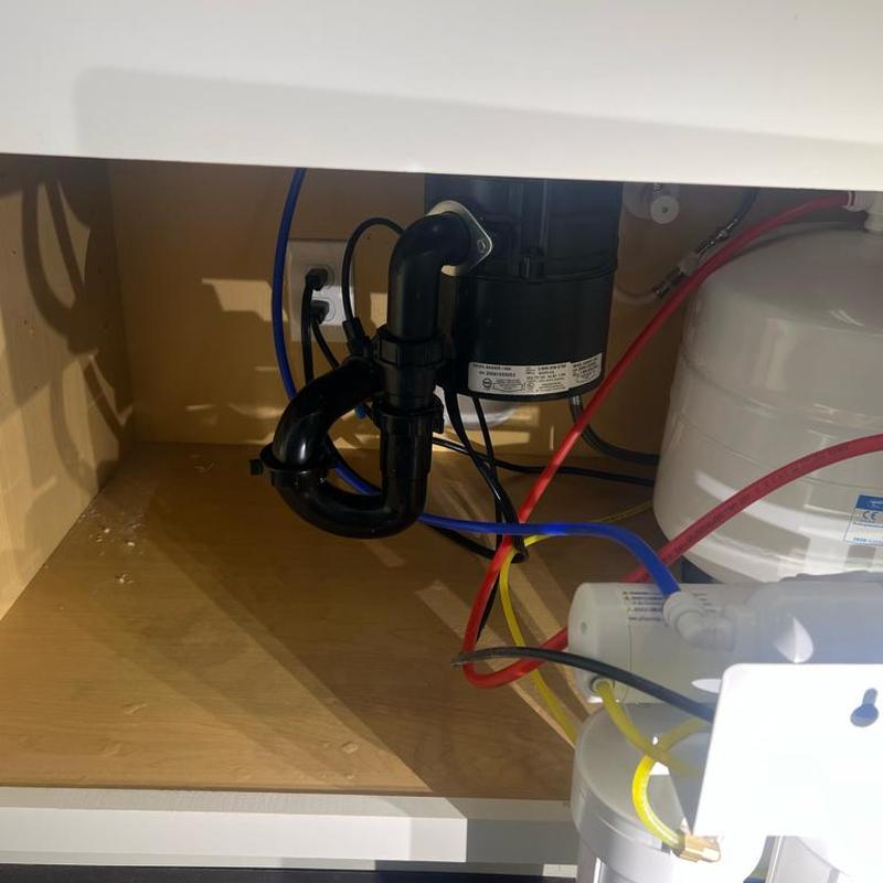 Reverse osmosis system drain and water lines under sink