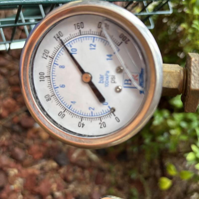 Pressure gauge on building water system, showing 140 psi Pressure gauge on building water system, showing 140 psi