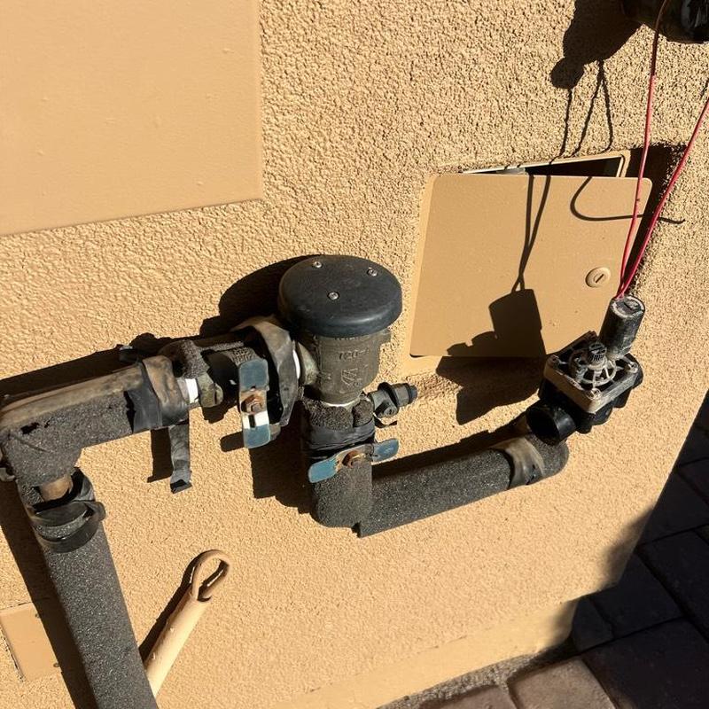 Irrigation valve and pipes with wiring outside wall