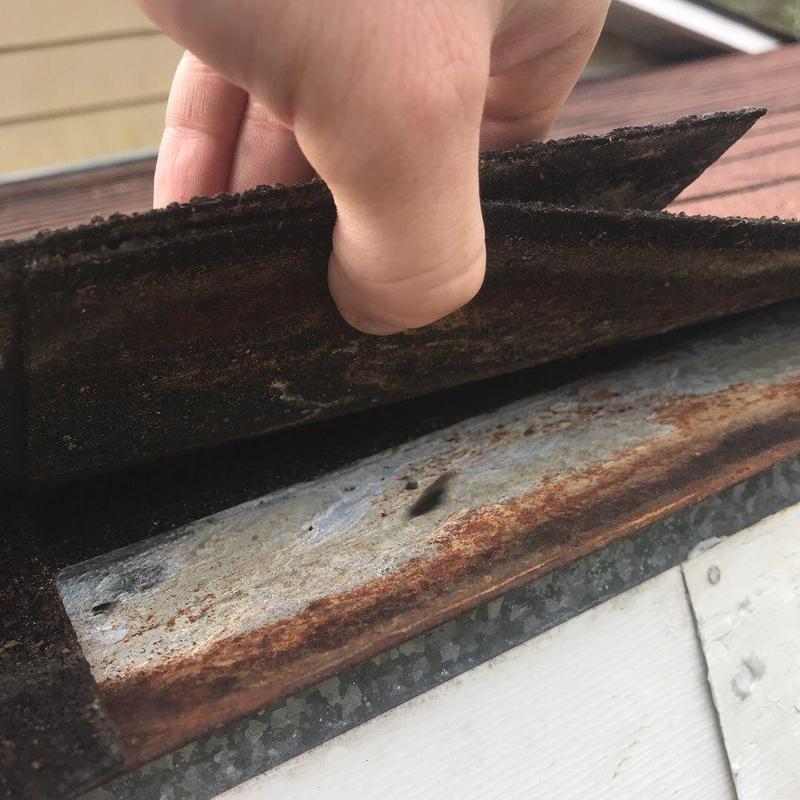 Metal drip edge with rust during roof inspection