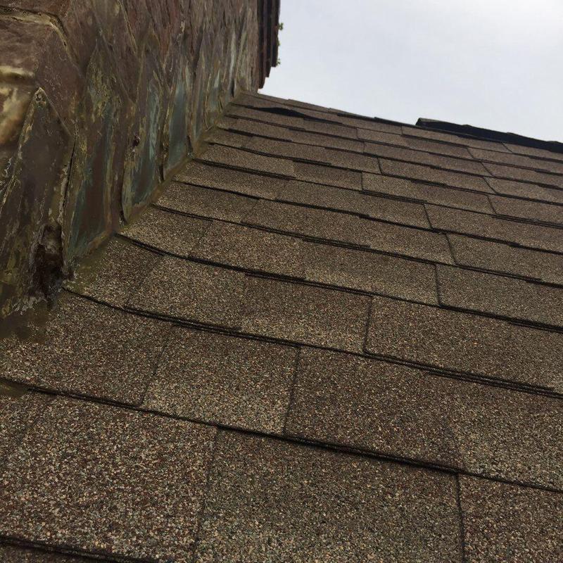 Roof shingles near metal flashing on sloped roof
